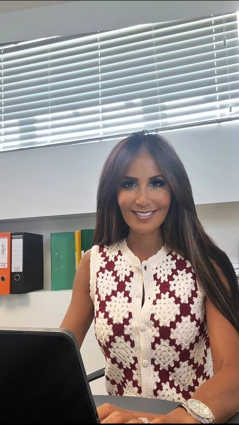 Mimi smiling at her desk